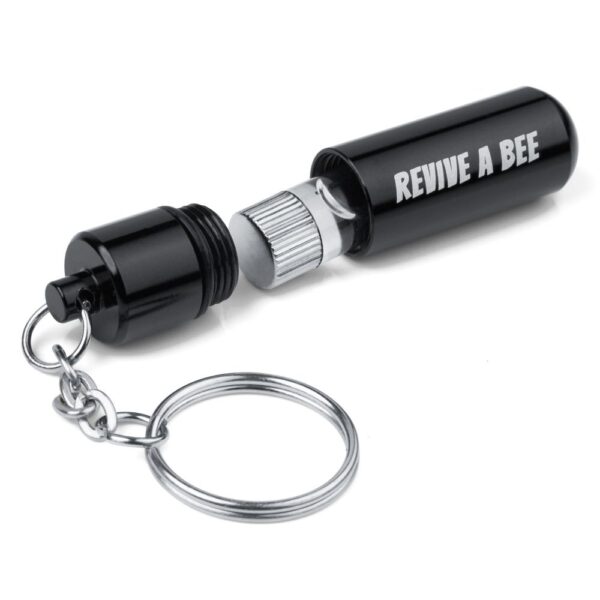 Black Revive a Bee keyring opened to show the bee revival vial